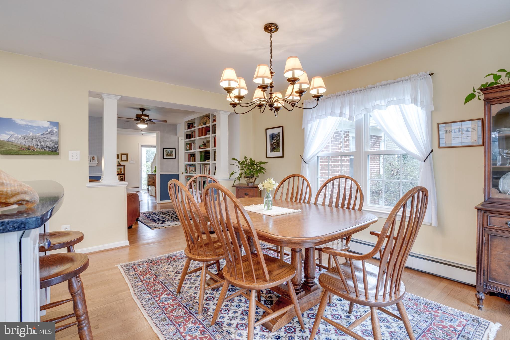 8901 Burke Road Burke, VA 22015 - Photo 13 of 63 a view of a dining room with furniture wooden floor and chandelier