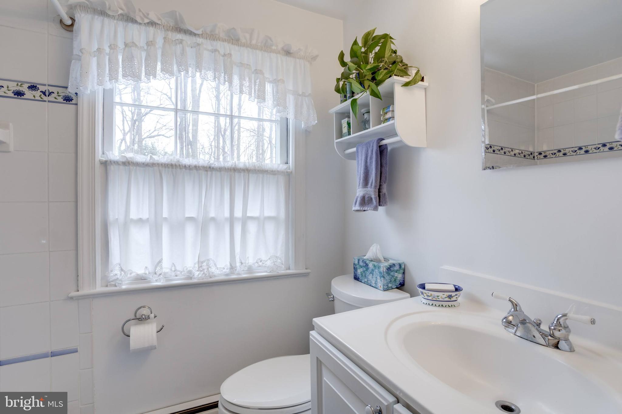 8901 Burke Road Burke, VA 22015 - Photo 35 of 63 a bathroom with a sink toilet and window