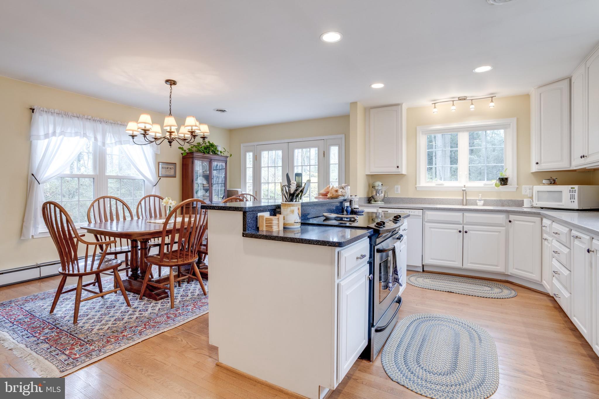 8901 Burke Road Burke, VA 22015 - Photo 7 of 63 a kitchen with a table chairs stove and cabinets
