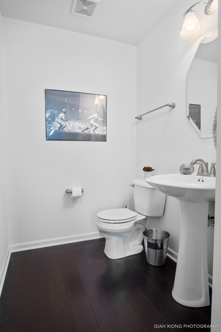 2908 Church Road Aurora, IL 60502 - Photo 13 of 26 a white toilet sitting next to a bathroom sink
