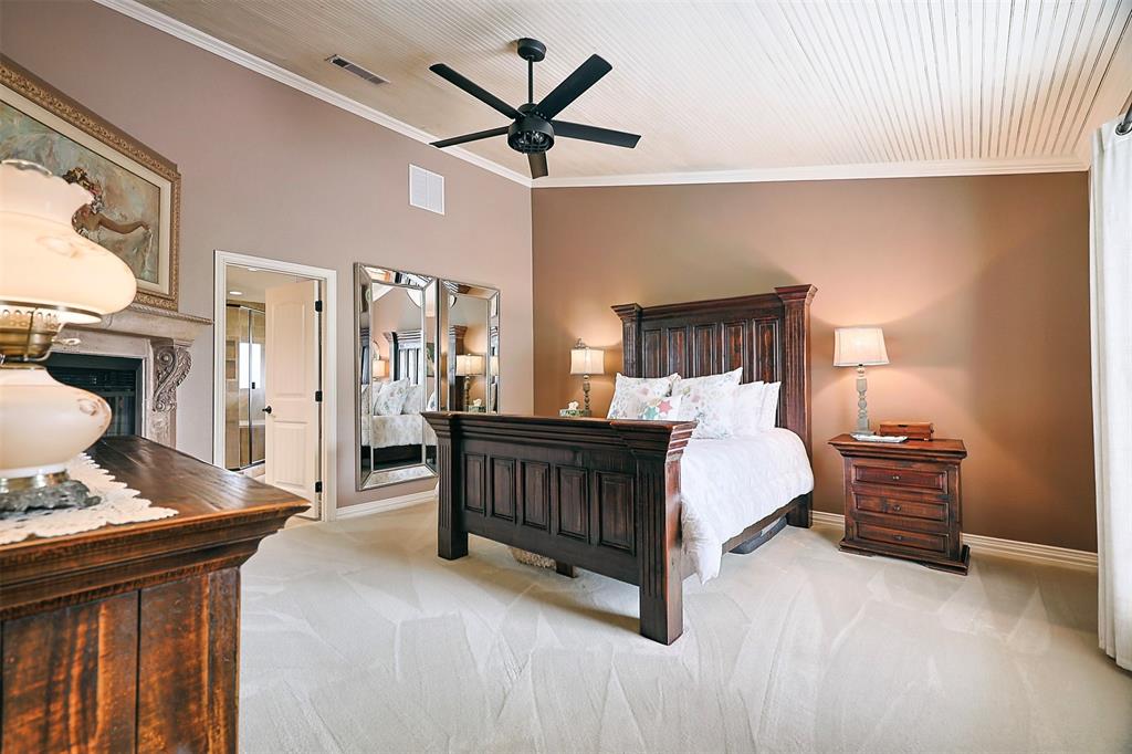 222 Bayne Road Haslet, TX 76052 - Photo 16 of 40 primary bedroom with vaulted ceiling and fireplace
