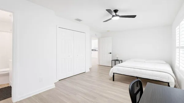 a bedroom with a bed and a chandelier