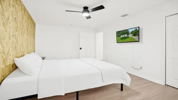 a bedroom with a bed and a chandelier