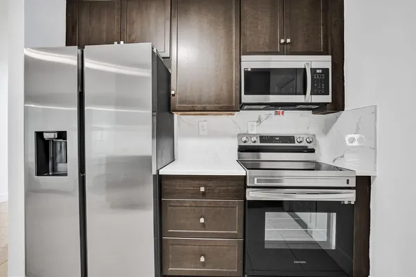 a kitchen with cabinets and stainless steel appliances