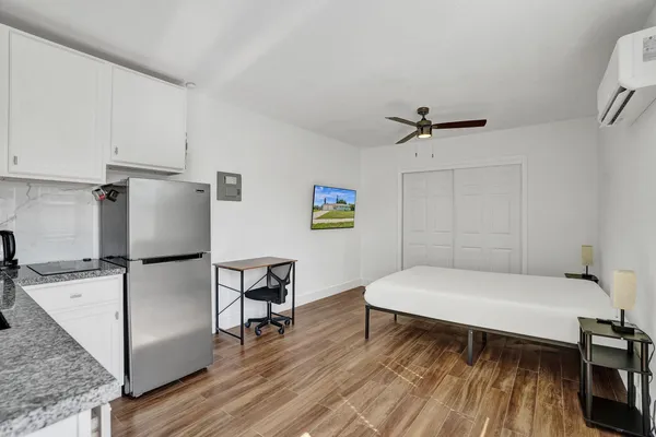 a room with a bed and a table with wooden floor