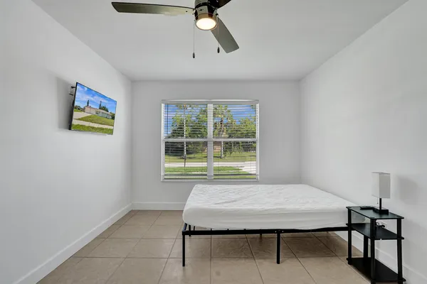a bedroom with a bed and a window