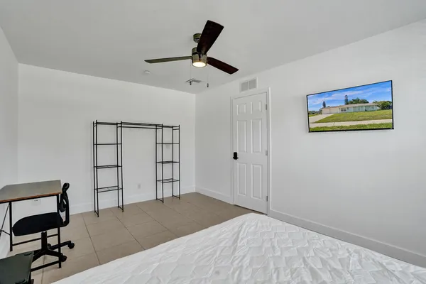 a bedroom with a bed and a bookshelf