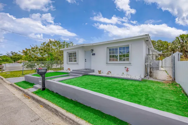 a view of a house with a yard porch and sitting area