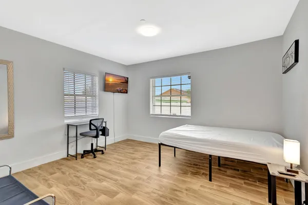 a workspace with furniture window and wooden floor