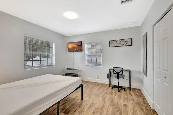 a bedroom with a bed and a window