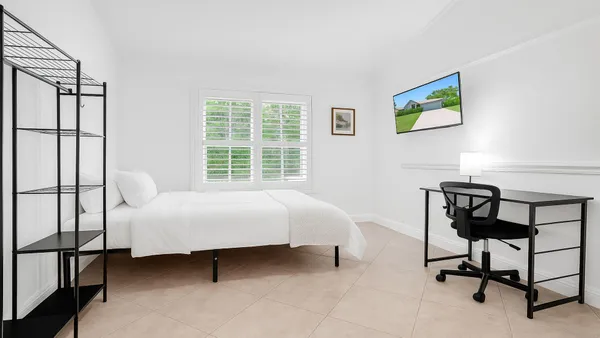 a bed room with a bed and a chair