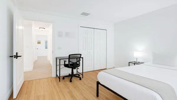 a bedroom with a bed and a table