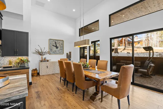 a dining room with furniture window and wooden floor