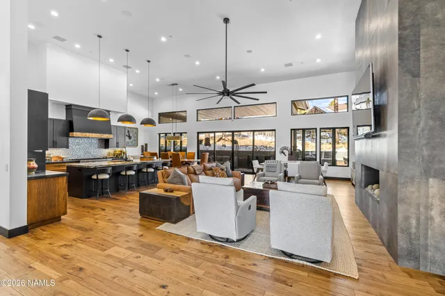 a living room with lots of furniture and kitchen view