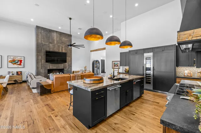a kitchen with stainless steel appliances granite countertop a stove and a large refrigerator