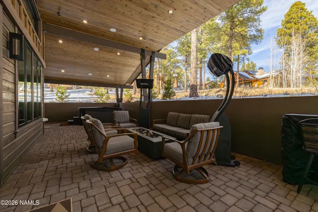 a living room with furniture and a floor to ceiling window