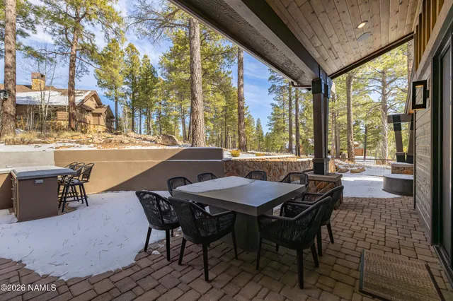 a dining room with furniture and a floor to ceiling window