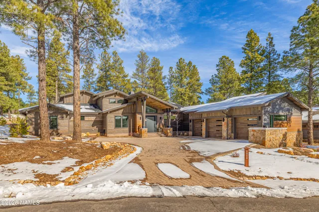 a view of a white house with a yard covered in snow