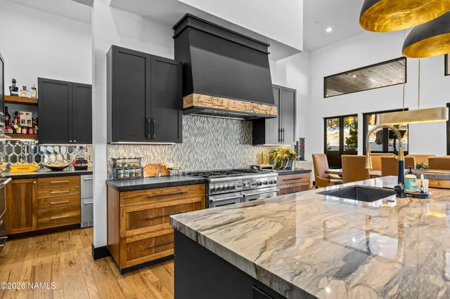 a kitchen with stainless steel appliances granite countertop a sink and cabinets