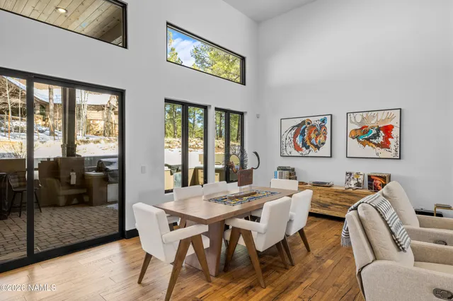 a view of a dining room with furniture large window and glass door