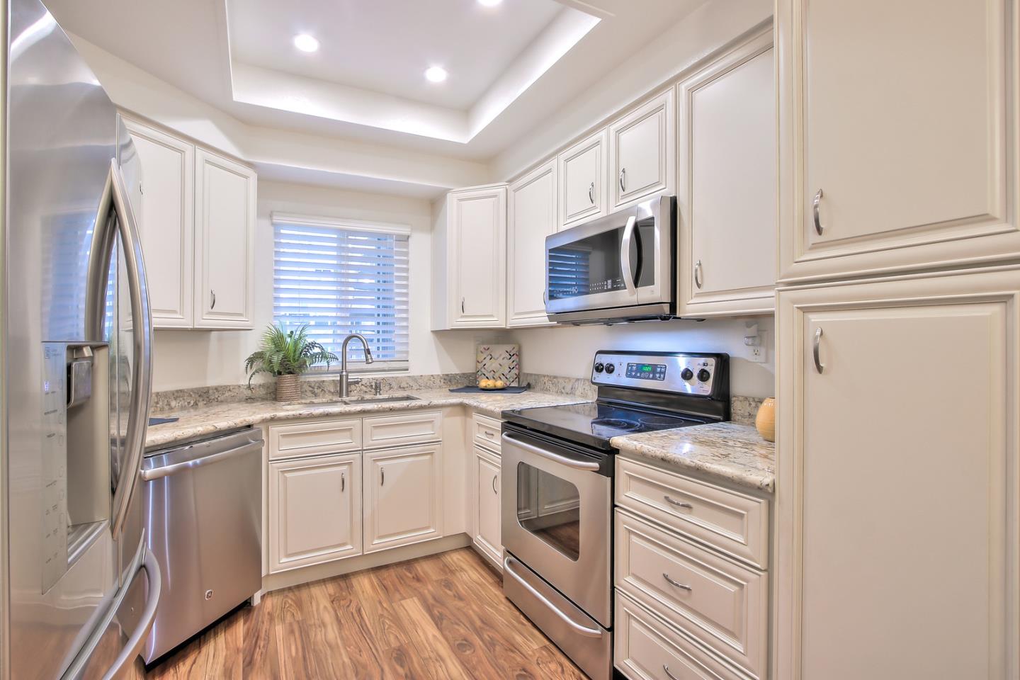 341 Shadow Run Drive San Jose, CA 95110 - Photo 14 of 25 a kitchen with white cabinets stainless steel appliances and sink