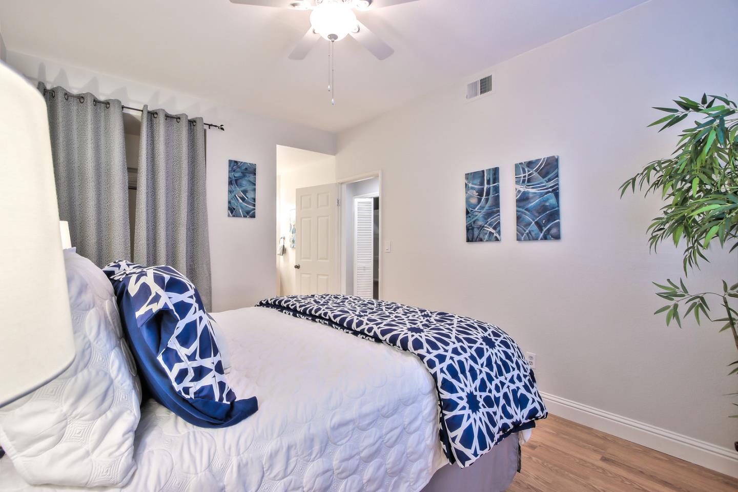 341 Shadow Run Drive San Jose, CA 95110 - Photo 16 of 25 a bedroom with a large bed and a chandelier