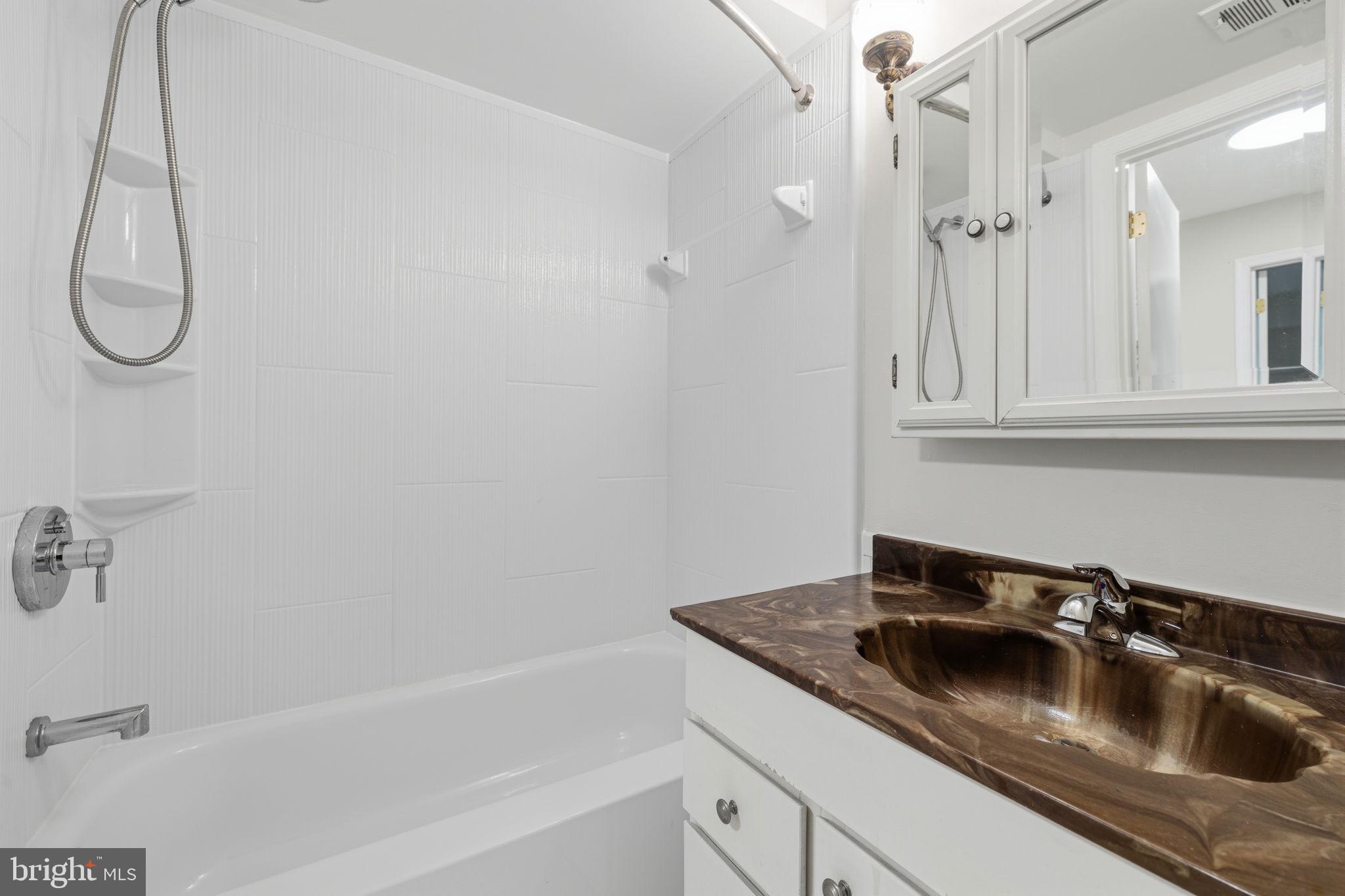 5817 Rexford Drive, Unit 798 Springfield, VA 22152 - Photo 15 of 23 a bathroom with a sink and a mirror