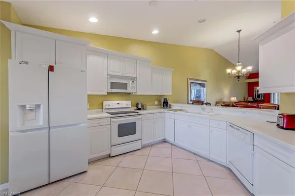 a kitchen with a sink stainless steel appliances and cabinets