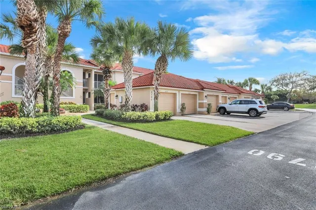 a front view of a house with a garden and trees