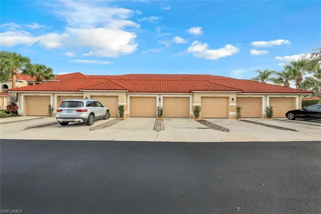 a car parked in front of white house