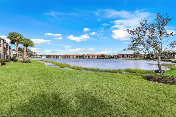 a view of a lake with houses in the back