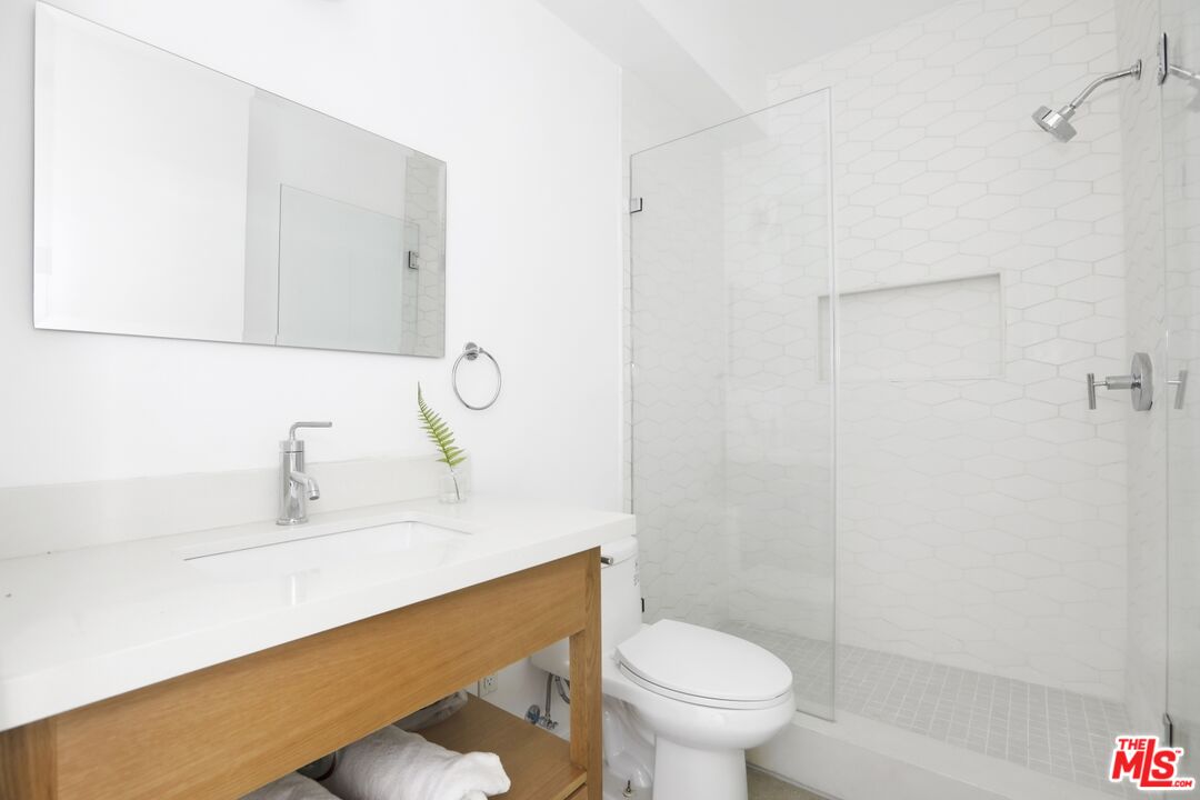 1411 West Roca Lane Los Angeles, CA 90041 - Photo 8 of 21 a bathroom with a sink a toilet and shower