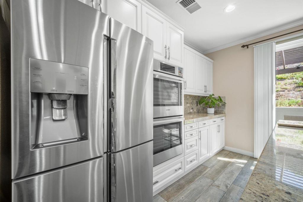 2781 Rambling Vista Road Chula Vista, CA 91915 - Photo 11 of 50 a kitchen with stainless steel appliances a refrigerator sink and cabinets