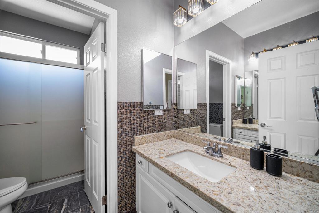 2781 Rambling Vista Road Chula Vista, CA 91915 - Photo 30 of 50 a bathroom with a granite countertop sink toilet and shower