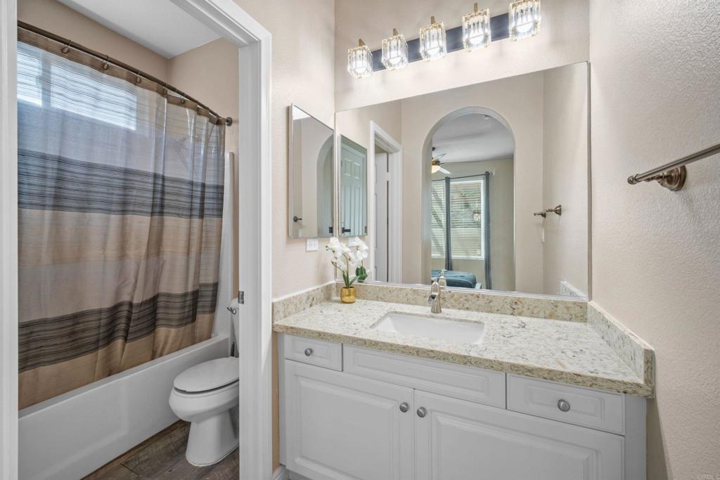 2781 Rambling Vista Road Chula Vista, CA 91915 - Photo 34 of 50 a bathroom with a granite countertop sink toilet and shower