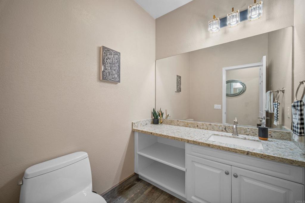 2781 Rambling Vista Road Chula Vista, CA 91915 - Photo 37 of 50 a bathroom with a granite countertop toilet sink and mirror