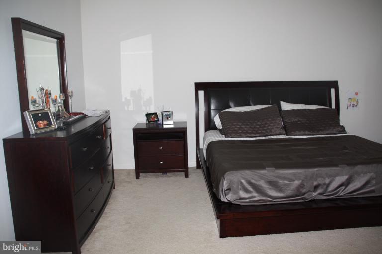 1256 Steed Street Ranson, WV 25438 - Photo 6 of 16 a bedroom with a bed and a mirror