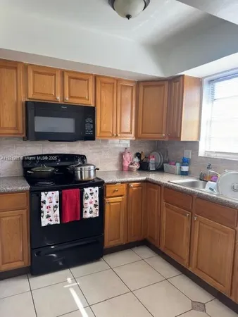 a kitchen with stainless steel appliances a stove a microwave and cabinets