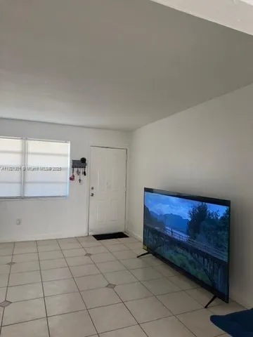 a view of a livingroom with an empty space and window