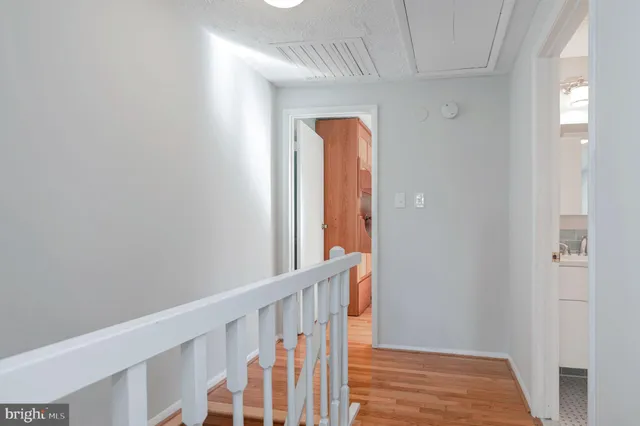 a view of hallway with wooden floor