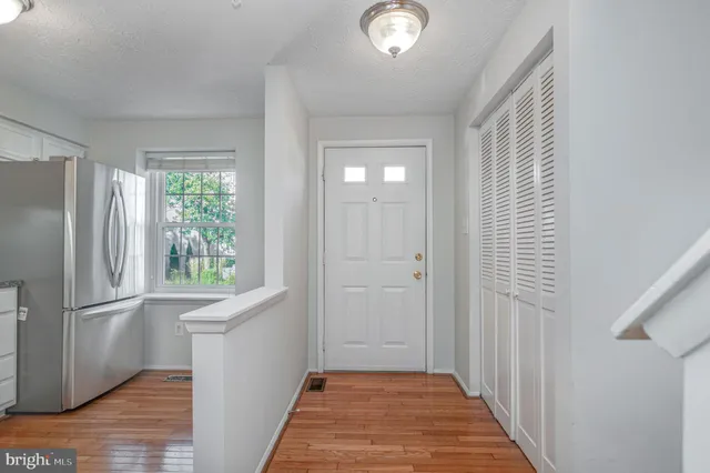 a view of a hallway view with wooden floor and staircase