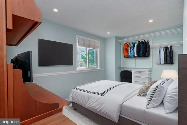 a bedroom with a bed and a television