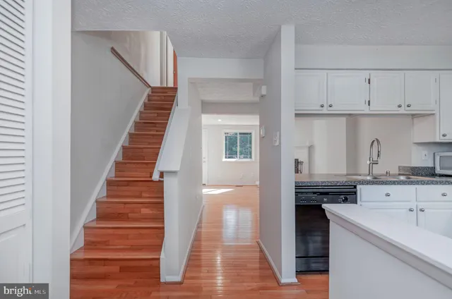 a kitchen with granite countertop a stove and a sink