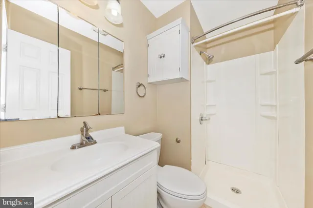 a view of a room with a ceiling fan and a window