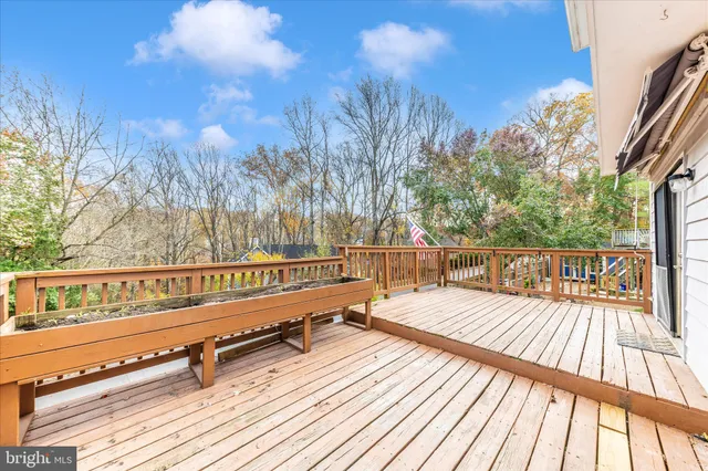 an aerial view of a house with a yard swimming pool and green space