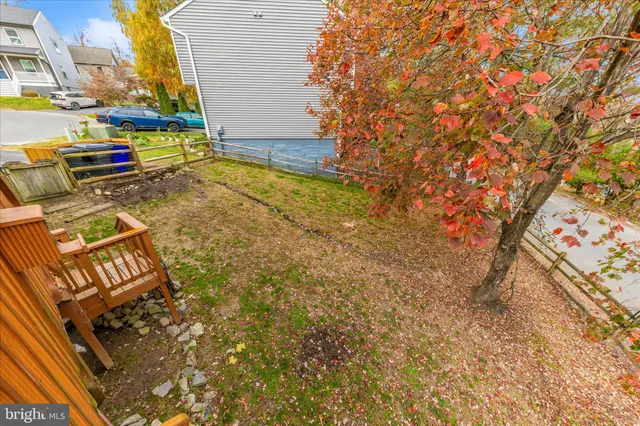 a view of a backyard with lawn chairs