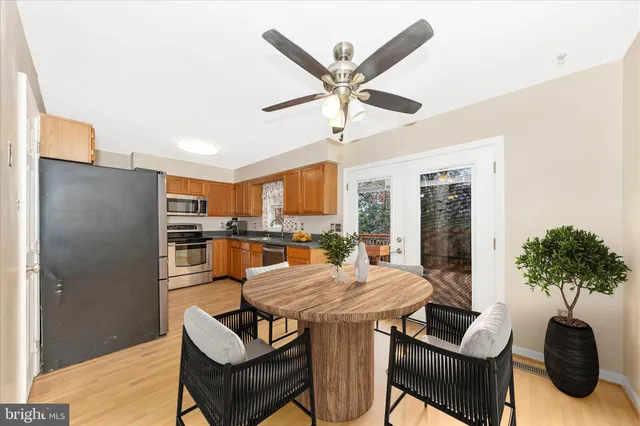 a kitchen with stainless steel appliances kitchen island granite countertop a refrigerator and a sink