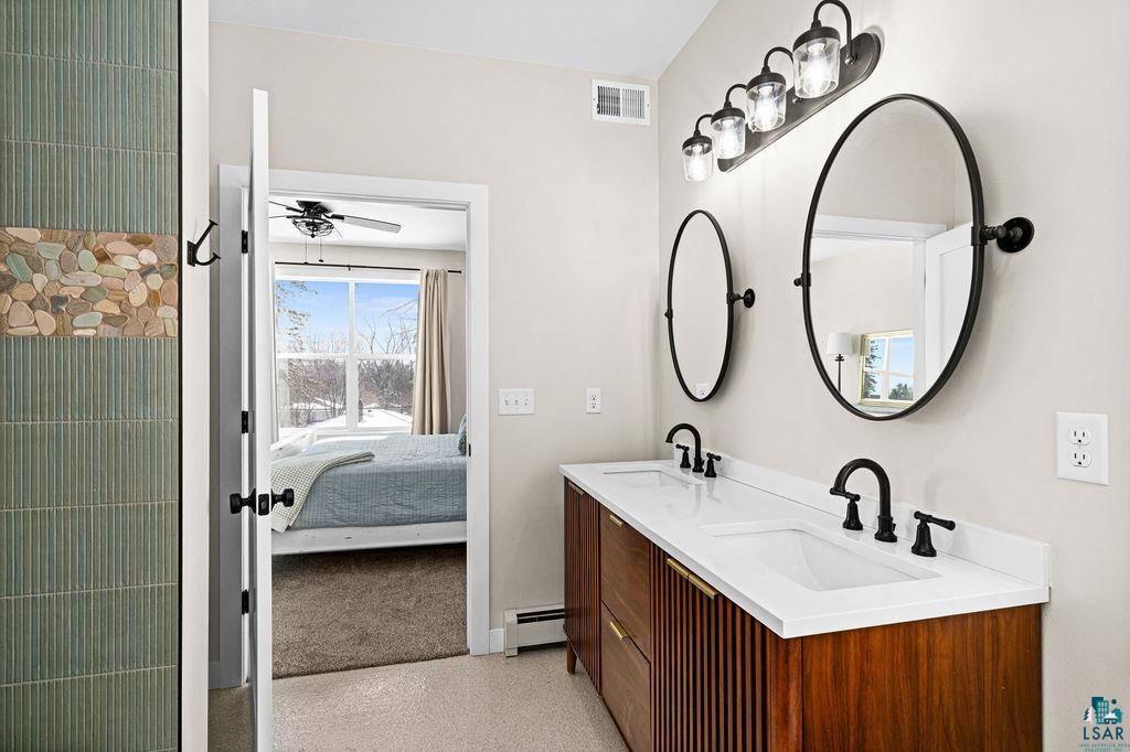 2236 Hoover Street Duluth, MN 55811 - Photo 20 of 52 Ensuite bathroom featuring double vanity, a baseboard heating unit, and a ceiling fan