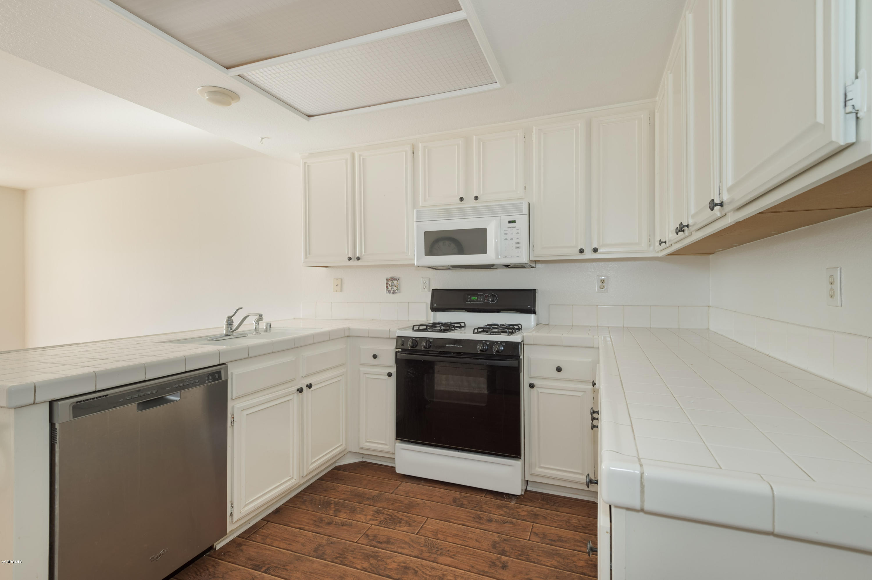 844 Congressional Road Simi Valley, CA 93065 - Photo 14 of 38 a kitchen with stainless steel appliances granite countertop a sink and cabinets with wooden floor