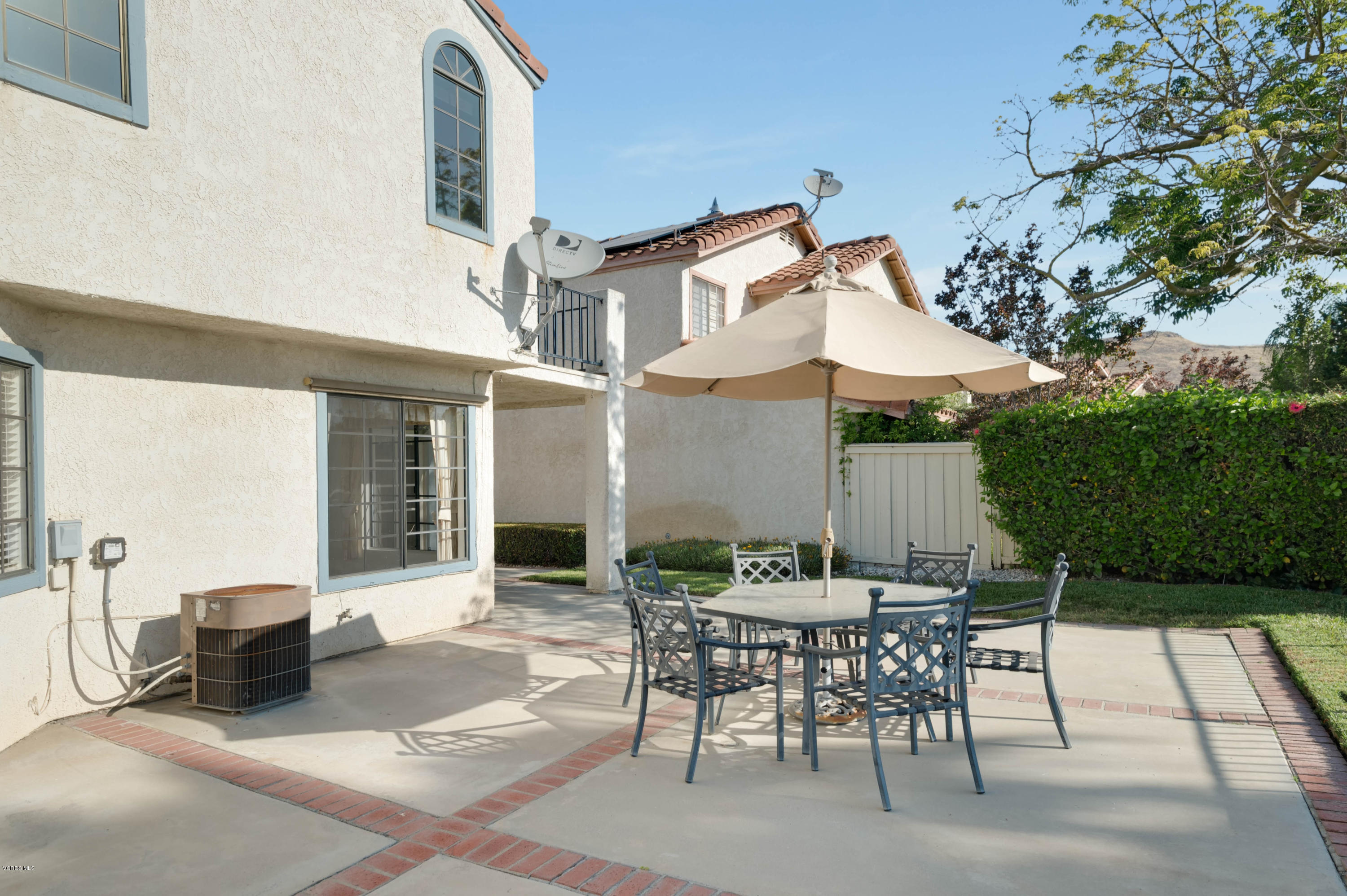 844 Congressional Road Simi Valley, CA 93065 - Photo 35 of 38 a view of a patio with a table and chairs under an umbrella
